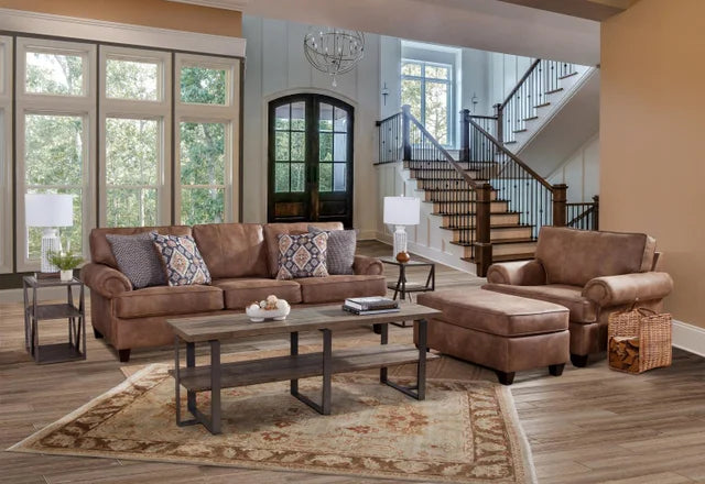 Living room with brown sofa, armchair, and coffee table in a well-lit room.